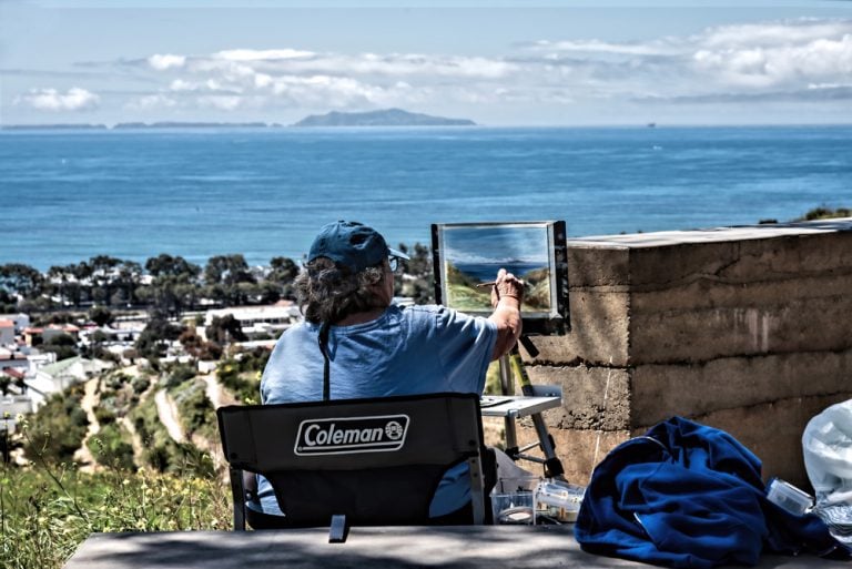 A scenic view of a plein air painter capturing Ventura Botanical Gardens overlooking the ocean.